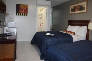 een hotelkamer met 2 bedden en een koelkast bij Sunrise Inn in Parry Sound
