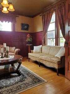 a living room with a couch and a table at The Home Place Inn in Kensington