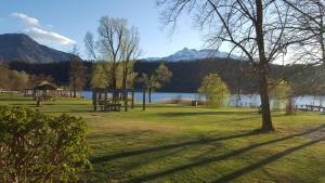 a park with a picnic table and a lake at Casa Martello in Levico Terme