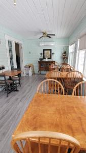 a dining room with wooden tables and chairs at The Home Place Inn in Kensington