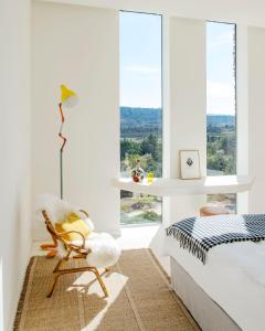 a bedroom with a bed and a window at Les Milles Roches in Gordes