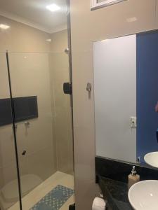 a bathroom with a glass shower and a sink at Studio miguel II in Rio de Janeiro