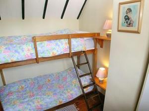 A bunk bed or bunk beds in a room at Chapel Cottage 