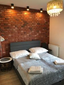 Łóżko lub łóżka w pokoju w obiekcie Gdansk Apartament Harmonia Oliwska