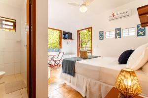 a bedroom with a bed and a bathroom at Jeri Pousada in Jericoacoara