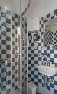 a bathroom with a shower and a sink and a toilet at City center apartment Roza in Makarska