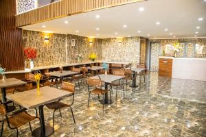 a restaurant with tables and chairs and a bar at LA MIA Lakeview Hotel in Pleiku