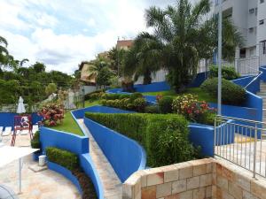 a row of blue stairs with bushes and plants at Residencial Thermas Caldas in Caldas Novas
