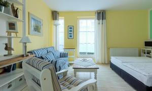a bedroom with a bed and a living room at Marikens Deel in Ahrenshoop