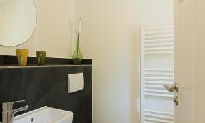 a bathroom with a sink and a mirror at Haus Schilfkante - Wohnung 1 in Wieck +21 photos