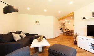 a living room with a couch and a tv at Haus Schilfkante - Wohnung 1 in Wieck