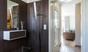 a bathroom with a sink and a mirror on a wall at Haus Seeschwalbe in Ahrenshoop +22 photos