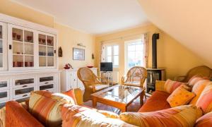 a living room with a couch and chairs and a table at Madlen in Ahrenshoop