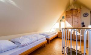 a bedroom with three beds in a room at Madlen in Ahrenshoop