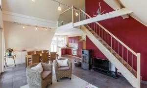 a living room with a staircase and a dining room at Boddenzauber 02 in Wieck +13 photos