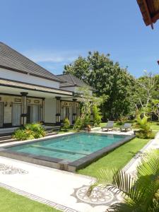 a swimming pool in the yard of a house at Nyang - Nyang Bungalow Uluwatu in Uluwatu