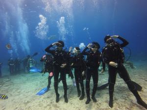 a group of people in wetsuits standing in the ocean at Shang Yuan in Green Island