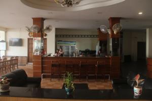 a living room with a bar and a kitchen at Dania in Pattaya Central