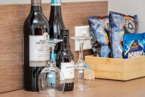 a group of wine bottles and glasses on a table at Roma Inland Motor Inn in Roma