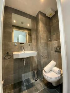 a bathroom with a sink and a toilet at Eyre Square Galway Central Self Catering in Galway +25 photos