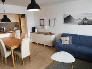 a living room with a blue couch and a table at Ferienwohnung- Alpengaudi in Missen-Wilhams