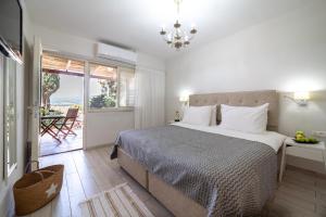 a bedroom with a large bed and a balcony at Holiday Village Kibbutz Mizra in Mizra‘