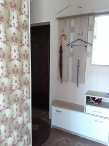 a kitchen with a counter and an umbrella on the wall at Saulriets in Liepāja +16 photos
