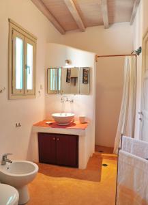 a bathroom with a sink and a toilet at Alonistria in Órmos Aiyialís