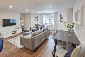 a living room with a couch and a table at Host & Stay - The Garden Apartment in Harrogate