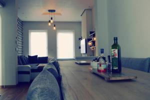 a living room with a bottle of wine on a table at Villa Maredan in Ostend
