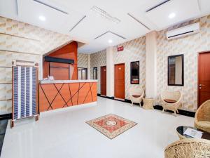 an empty room with chairs and a lobby at OYO 90341 Sean's Residence in Medan