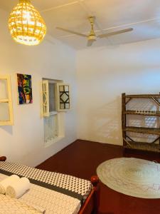 a bedroom with a bed and a ceiling fan at Zava House Stone town in Zanzibar City