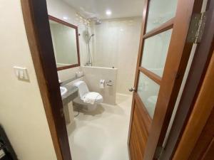 a bathroom with a toilet and a sink and a mirror at Smile House - Fisherman Village in Bophut