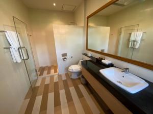 a bathroom with a sink and a mirror and a toilet at Smile House - Fisherman Village in Bophut