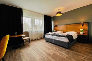 a hotel room with a bed and a desk and a table at MB Hotel in Bremen +29 photos