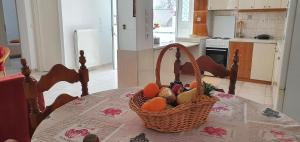 a basket of fruit on a table in a kitchen at Ailamakis Apartements in Zekros