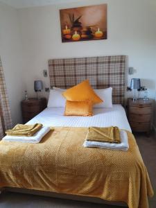 a bed with a white bedspread and pillows in a bedroom at The Star and Garter Hotel in Linlithgow