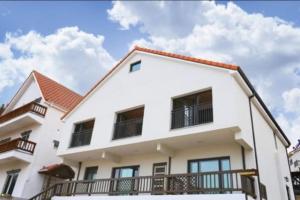 a white house with a red roof at Namhae Manheim pension in Namhae +5 photos