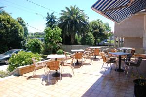 a group of tables and chairs on a patio at Hotel Galaico in Sanxenxo