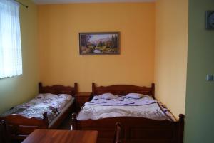 2 camas individuales en una habitación con mesa en Apartament Jozefina, en Szklarska Poręba