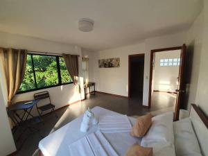 a living room with a white bed and a couch at Mango Prima in Moalboal