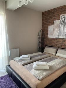 two beds in a bedroom with towels on them at Apartamenty Bartnicza C in Bielsko-Biała