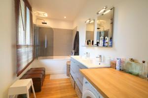 a bathroom with a sink and a mirror at LESPARISNORMANDS - le duplex de la reine in Boulogne-Billancourt