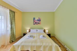 ein Schlafzimmer mit einem großen Bett und zwei Handtüchern in der Unterkunft DuMalux corner in Subotica