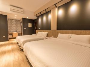 Rúm í herbergi á Yujing B&B 2