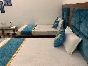 a bedroom with a bed and pillows on the floor at Hotel Maha Luxmi Palace in Katra