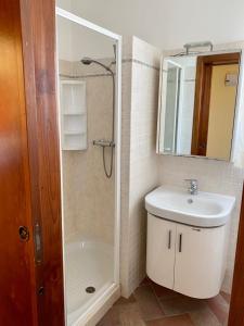 ein Bad mit einer Dusche, einem Waschbecken und einem Spiegel in der Unterkunft La Cappuccina in Galatone