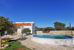 a swimming pool in the yard of a house at Hvar Mediterranean Ranch House in Stari Grad