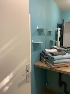 a bathroom with a mirror and some towels on a shelf at Bel appartement 4 personnes balcon, centre ville in Le Touquet-Paris-Plage +45 photos