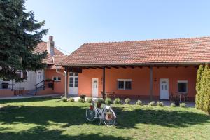 a bike parked in the yard of a house at DuMalux Garden in Subotica